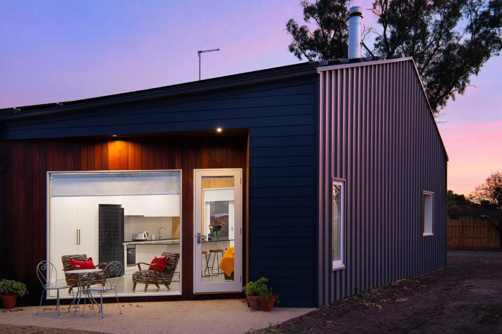 Modern house exterior at sunset with open kitchen