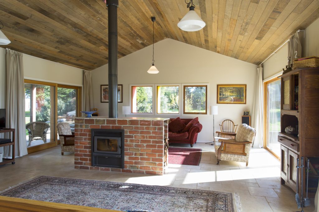 Spacious living room with cosy decor and fireplace.